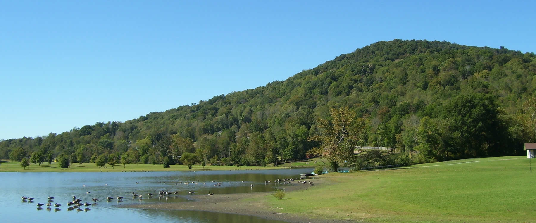 INDIAN MOUNTAIN STATE PARK Campbell County, TN Indian Mountain State Park is a multi-use facility in Campbell County near Tennessee's northern border. Visitors to the 203-acre park enjoy fishing at the lake, picnicking, camping, and hiking on the three trails. Although the park's name would indicate that it is located on a mountain, it is actually located at the base of the mountain.