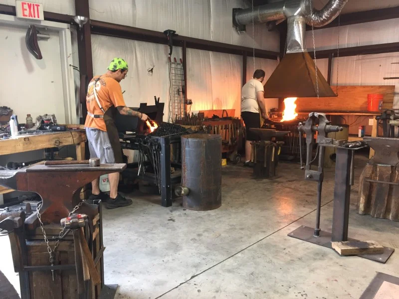 Mitty’s is a blacksmith metal art studio and storefront located in the historic town of Cumberland Gap, Tennessee. Most days you will find Ryan Schmidt, metal artist and owner of Mitty's in the studio making a table, a bottle tree or perhaps working on a custom order. Ryan specializes in custom made functional objects, ornamental ironwork, sculptures, furniture, and fixtures, public, and private commissions. The studio is located next door to the storefront, aka The Shop. The Shop at Mitty’s features living space furnishing, home décor, novelty to unique metal, wood, glass and other mediums. The featured products in The Shop at Mitty's are handmade by the local artist in Kentucky, Tennessee, and Virgina. Stop by and visit us today! We’re located at 519 Lynn Avenue, Cumberland Gap, Tennessee.