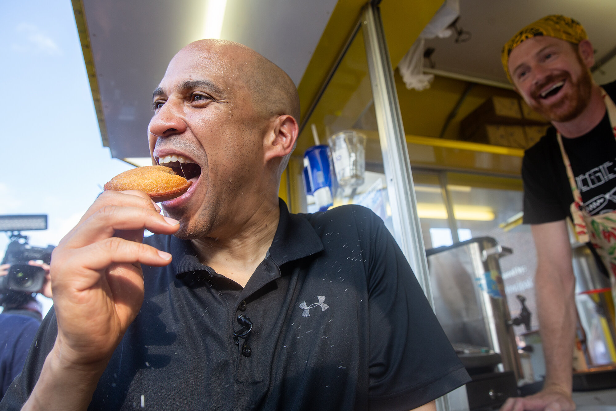  Sen. Cory Booker takes a bite out of a fried PB&amp;J on-a-stick at the Iowa State Fair on August 10, 2019 in Des Moines, Iowa. (For Buzzfeed News) 