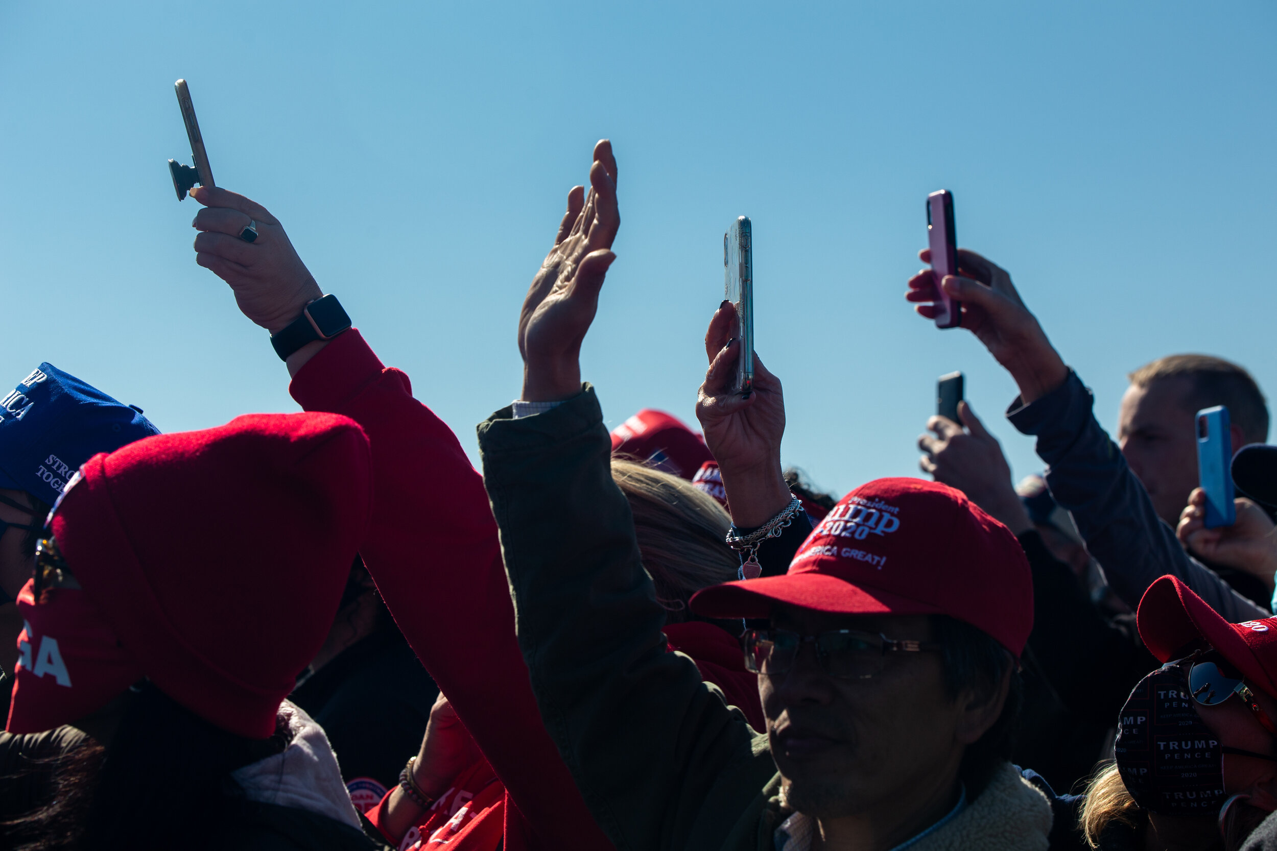  Attendees raise their phones during a Make America Great Again rally with Donald Trump on Nov. 2, 2020 in Fayetteville, North Carolina. (For Bloomberg) 