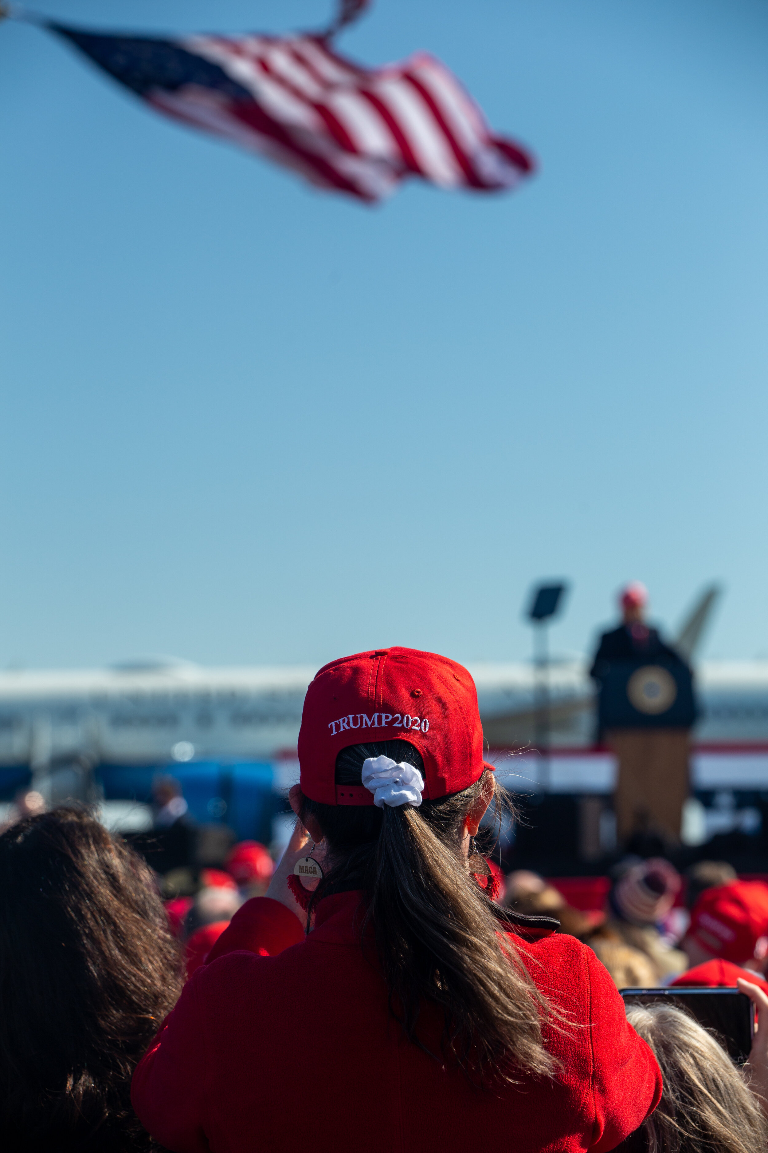  A woman watches on during a Make America Great Again rally with Donald Trump on Nov. 2, 2020 in Fayetteville, North Carolina. (For Bloomberg) 