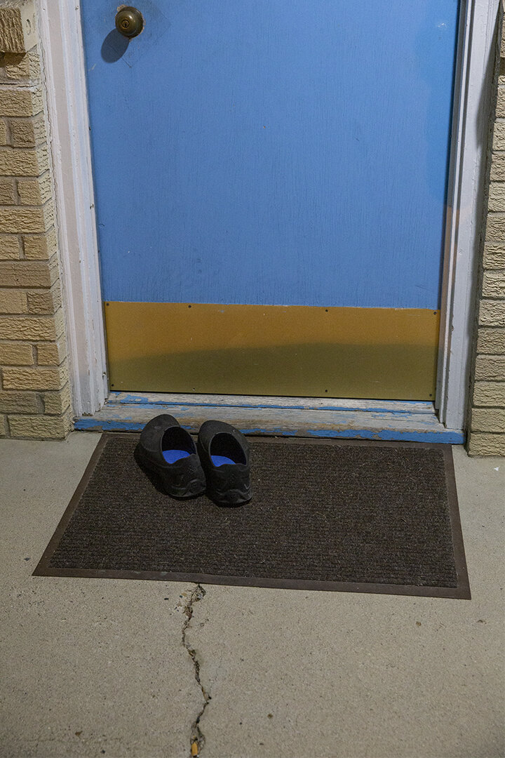  Shoes outside a door at the Blue Haven Hotel, Osceola. (Clarke County) 