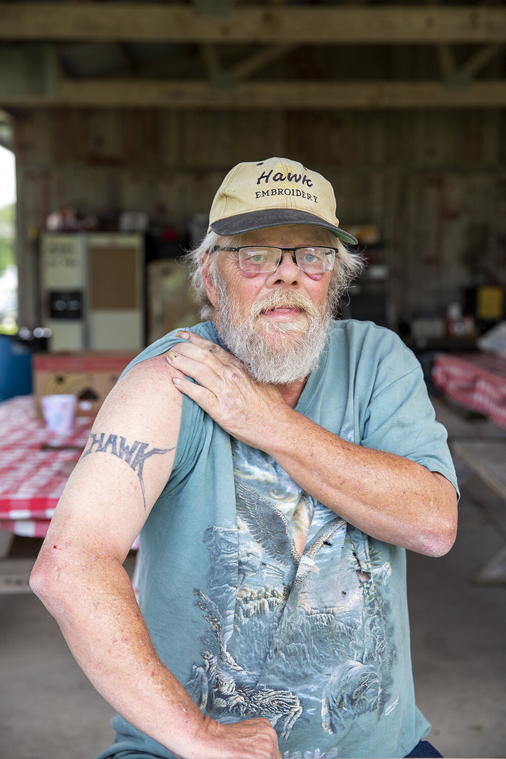  Hobo Hawk at a table in the Jungle, Britt. He arrived early to set up for the annual National Hobo Convention, a gathering and celebration of vagrants since 1900. Hawk has been coming to the convention for 18 years, where he has, on and off, held th