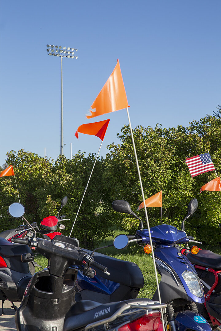  Mopeds near an athletic field at Atlantic High School, Atlantic. (Cass County) 