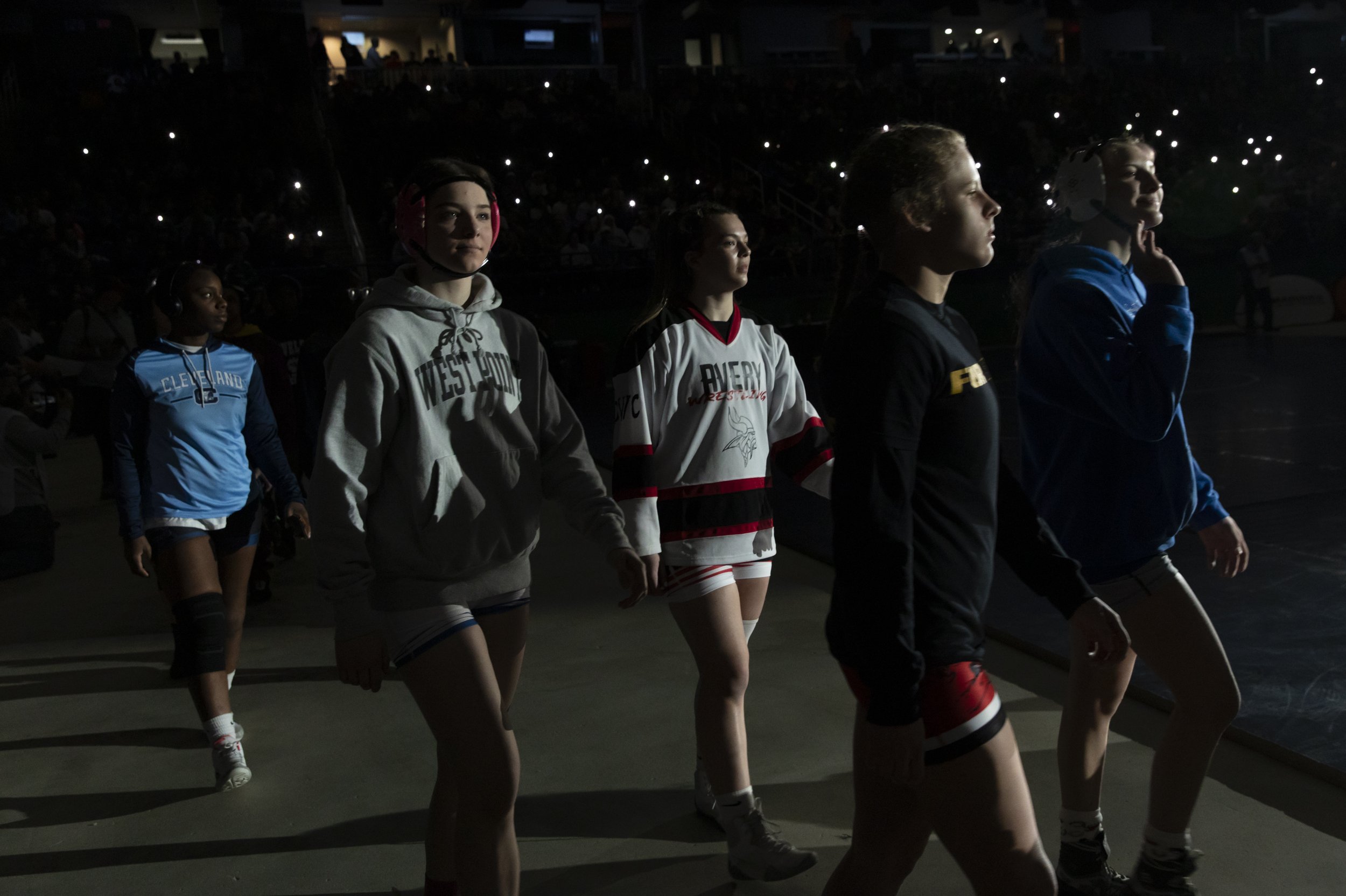  Wrestlers arrive on the floor before competing in the 2024 North Carolina High School Athletic Association’s first sanctioned women’s wrestling championship on Saturday, February 17, 2024 at the Greensboro Coliseum in Greensboro, NC. 