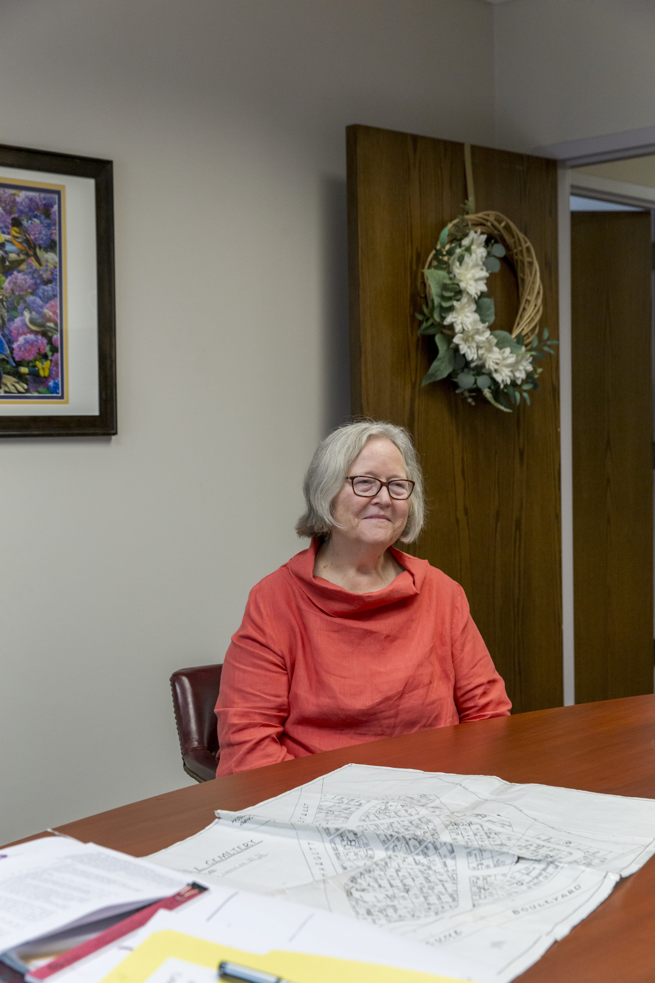  Jeri Kozobarich sits in front of a map of cemetery plots in the Jacksonville City Hall in Jacksonville, NC on Tuesday, July 18, 2023. (Rachel Jessen for NBC News) 