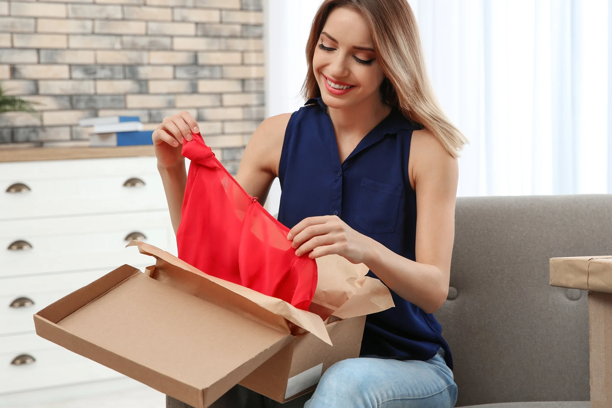 bigstock-Young-Woman-Opening-Parcel-On--284699284.jpg
