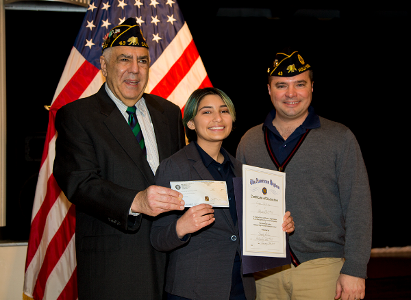 Cyan Jackson receives her winning certificate and prize from Randy Kahn and First Vice Commander, Fernando Rivero. 