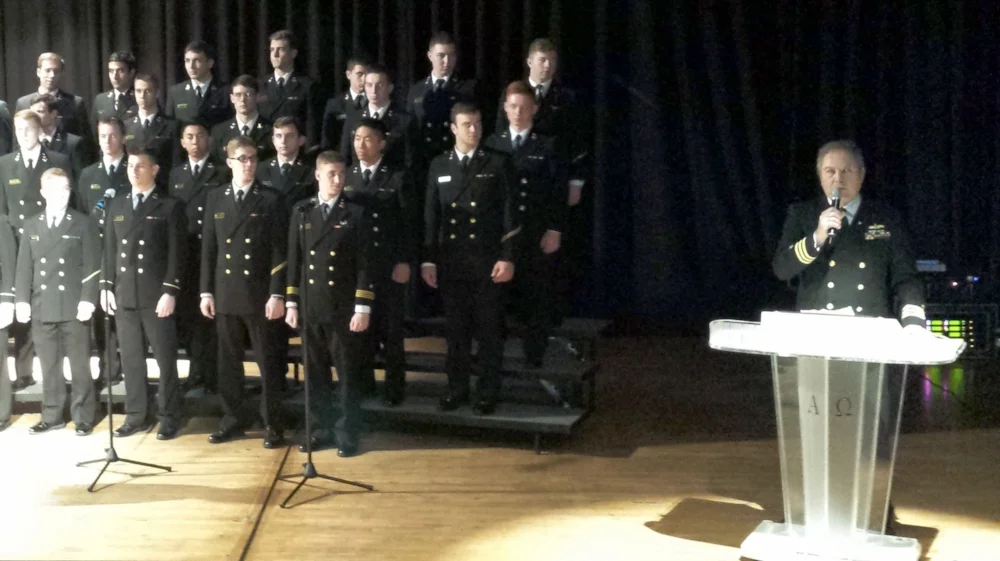 Post 43 member Kevin Glynn, USN (Ret.), far right, introduces the U.S. Naval Academy Men's Glee Club who performed at Los Angeles Senior High School on Friday, March 17. Students were also given information and a chance to ask questions about submitting for nominations to the Academy. (photo by Randy Kahn)
