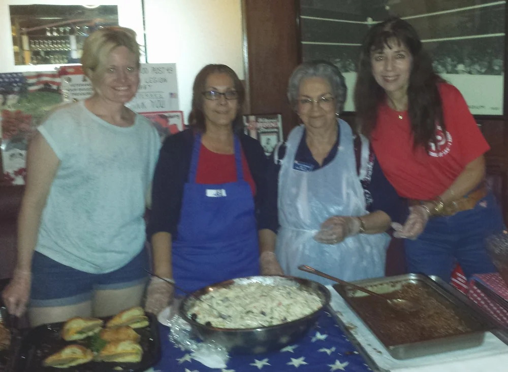 L to R: Tamra Brown, Elisa Corral, Dahlia Hernandez, and Trish Blanton, along with others from our dedicated Auxiliary Unit 43 working back in the kitchen, did a superb job of feeding the hordes of hungry attendees crowded in the Art Deco Bar after our Memorial Day service. (photo by Randy Kahn)