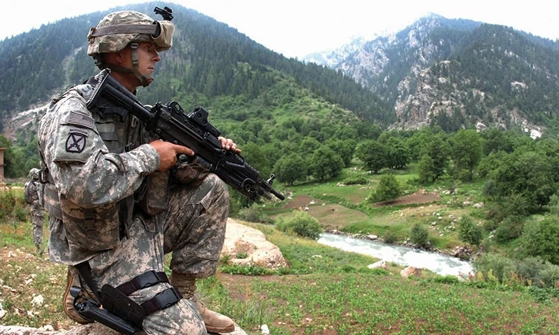 Spc. Jason Curtis, Charlie Company, 1st Battalion, 151st Infantry Regiment, pulls security while leaders of a medical civil action project search for a suitable site in Parun, Afghanistan, on June 28. (Photo by Sgt. Brandon Aird)
