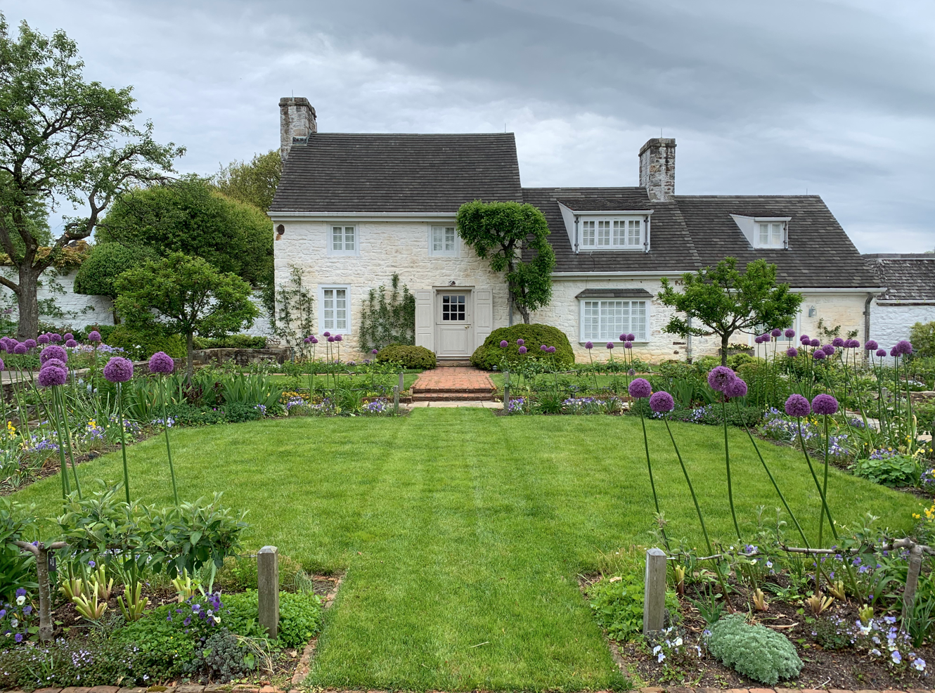  The Square Garden is formal in its symmetry and layout. Annual rye grass planted in the early spring helps set off the planting design and the charming guest house where Jackie Onassis and her family often stayed. 
