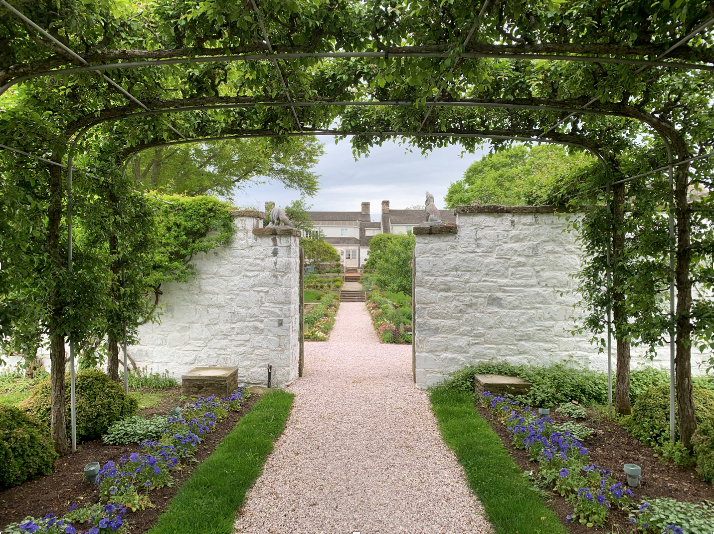  The Mary Potter crabapple arbor casts shade over the walkway leading into the formal garden.  