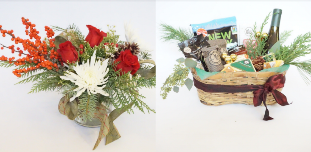 The medium basket is full of two bottles of wine, multiple cheese & meat, crackers, chocolate bars, and some fresh fruit.