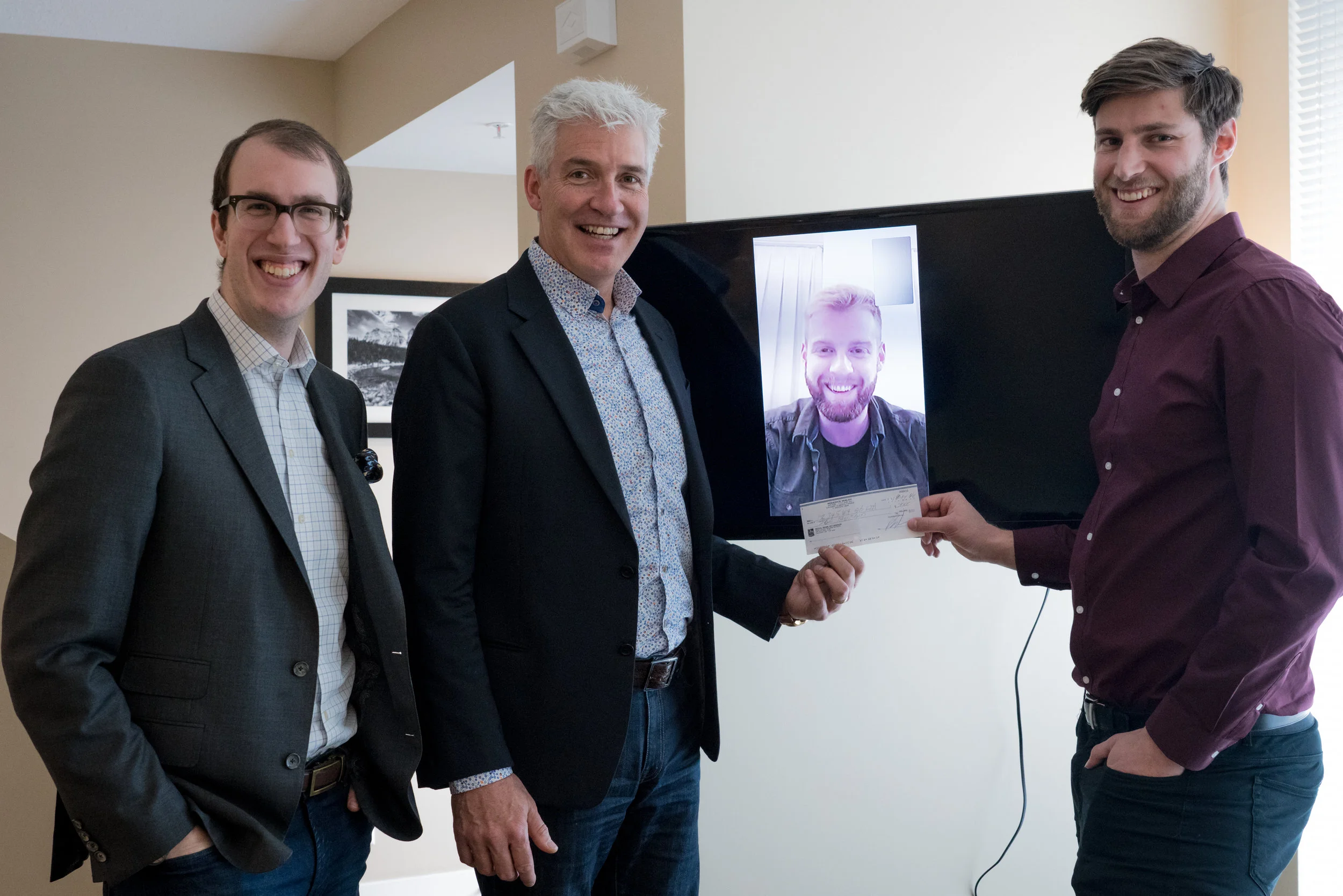 WM Wealth Representatives Mathew McDowell and Rod Walsh (left) with Brett Walsh (screen) and Calgary Premier League Director Jarron Meuller (right).