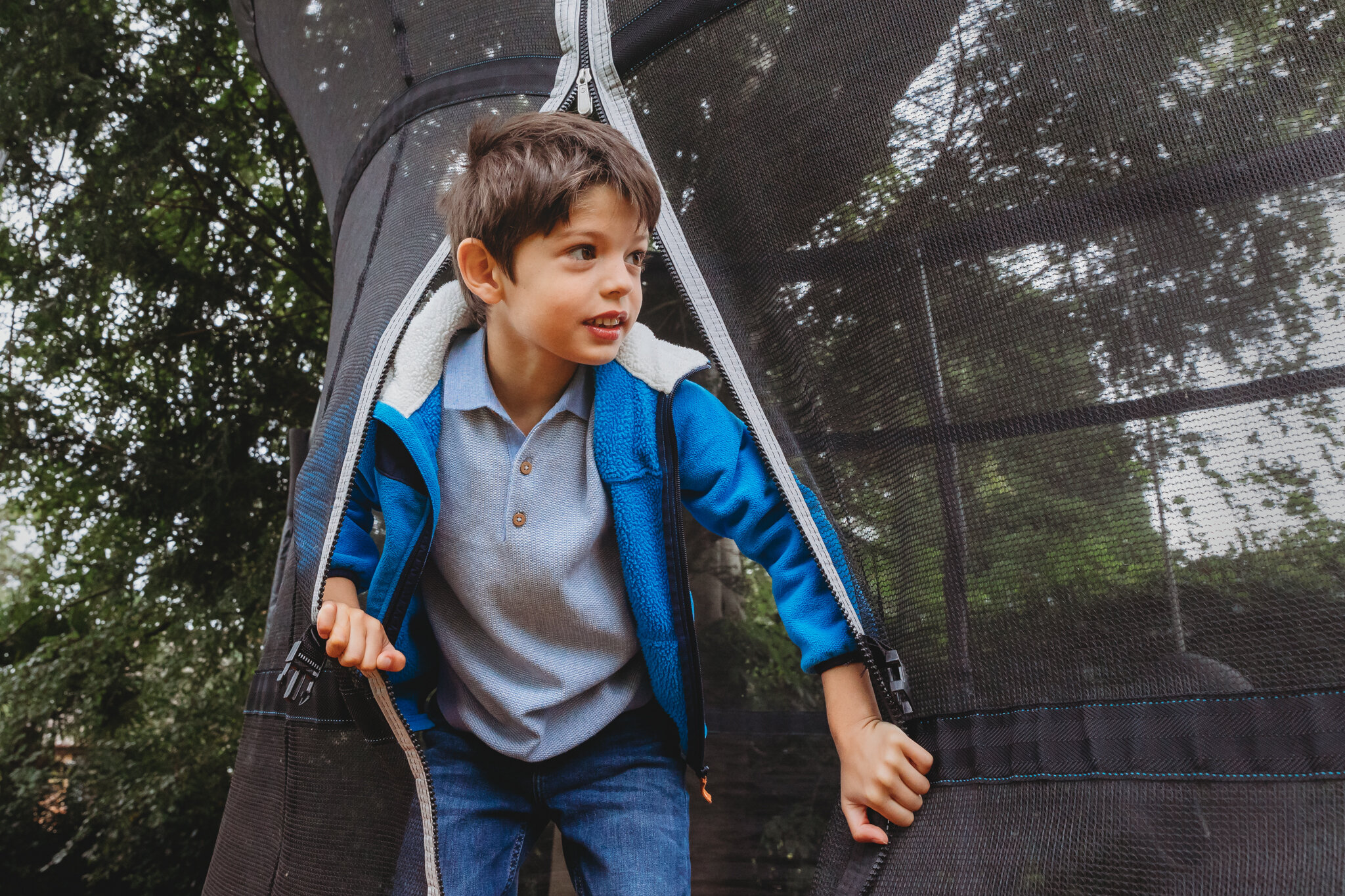 Boy peeking out from trampoline.jpg