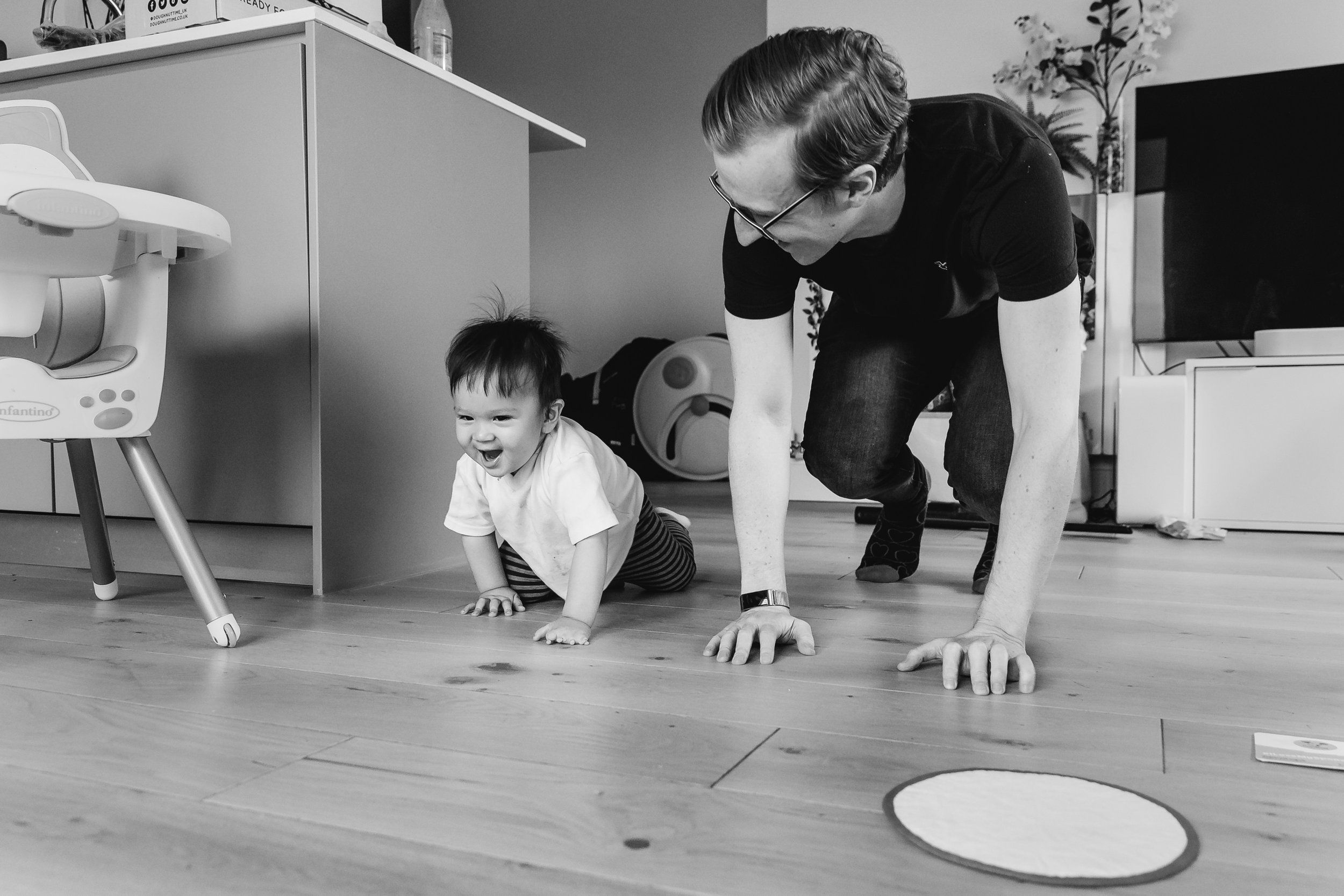 father crawling with baby on the floor