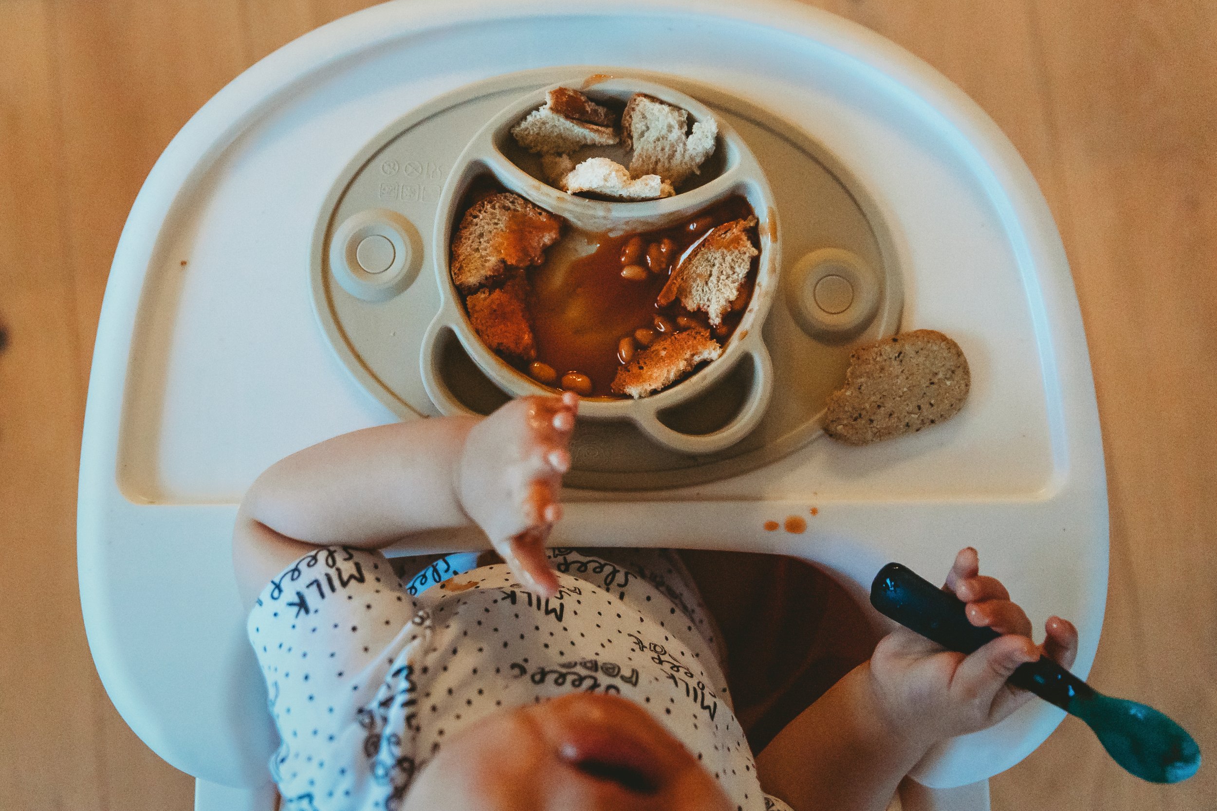 Top down view of baby eating in highchair