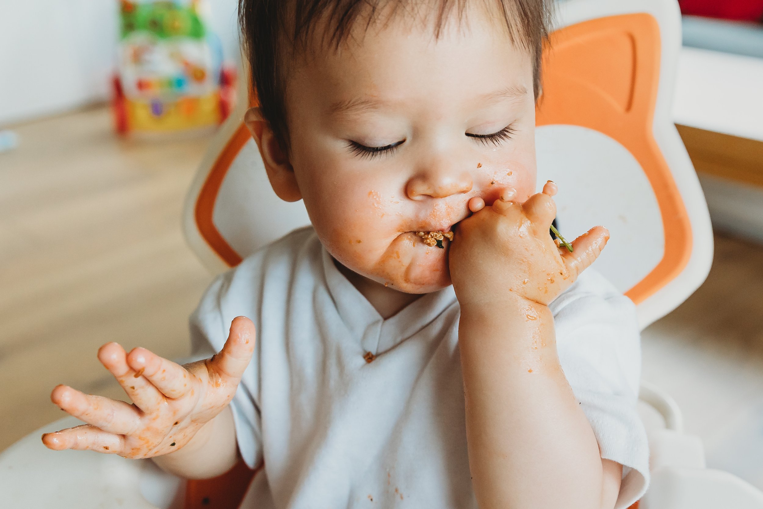 Baby eating in highchair