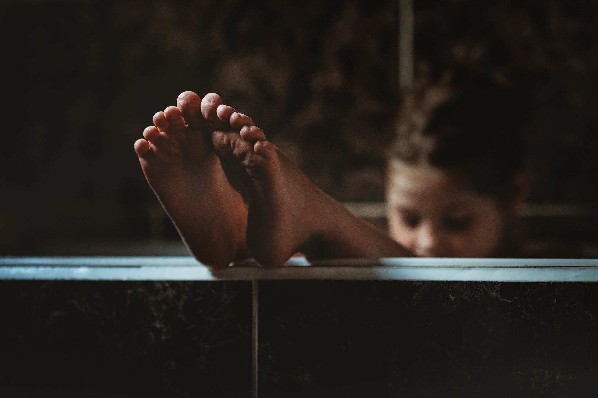 Girl with toes out of bath