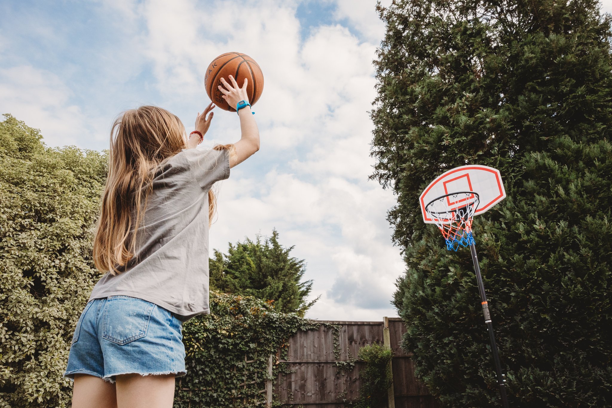 Girl shooting basketball