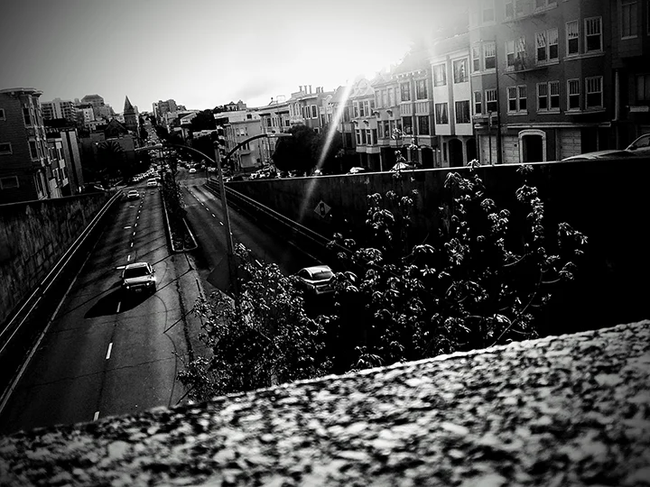 A view of the artist from another Black, white, gray, moments flashing in the darkness of the city. A photographer, one who lives, in, the city, walking and being in it, relating to it, engaging with its dark mysteries and beauty. This photographic artist captures the city from the intimacy of her own space. It is an externalization of her interiority. She is a working contributor of the 6th Street Photography Workshop.