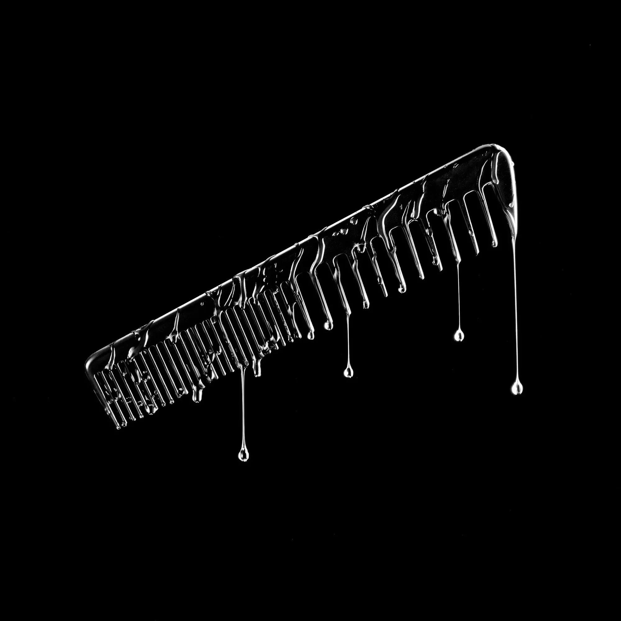 wet-comb-dripping-black-background.jpg