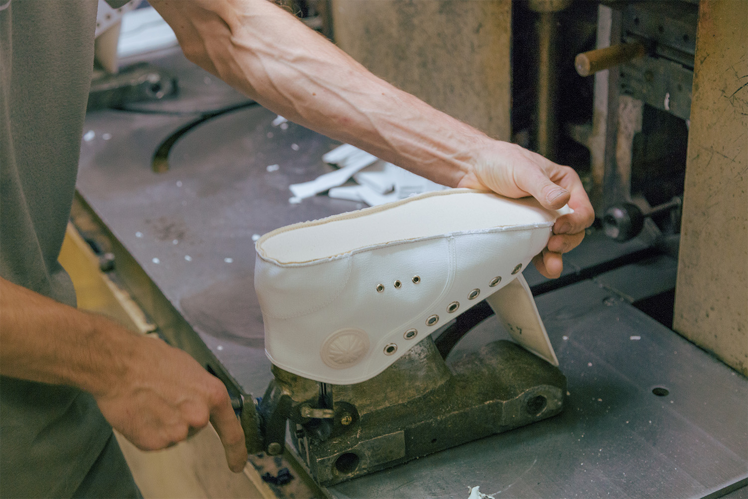 The shoe is mounted on a mold before the rubber is attached.