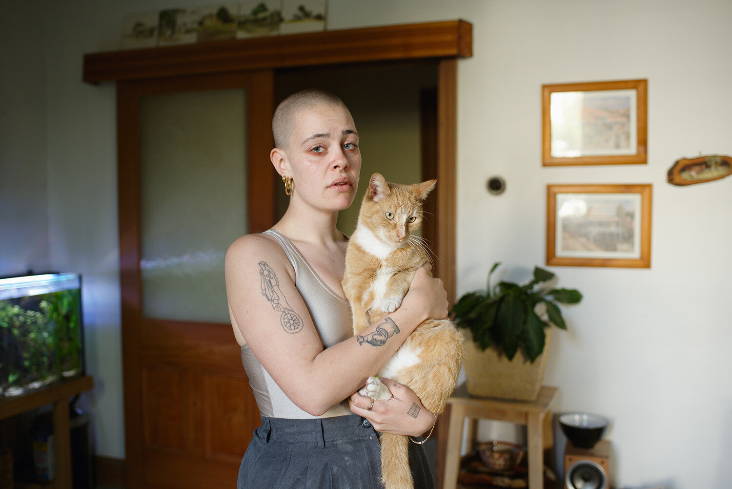 Agnes holding Lentil in their living room, Melbourne, Australia, 2019
