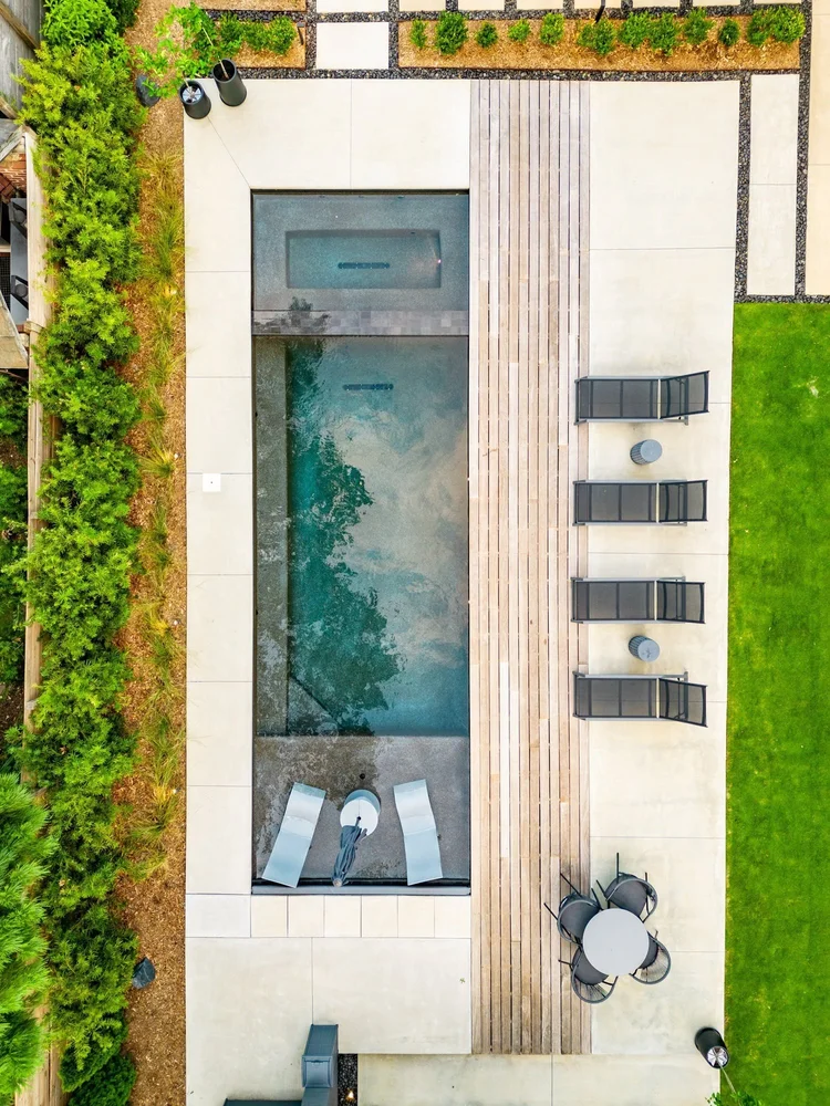 Aerial view of a custom home exterior in Greenville, SC, featuring a pool.