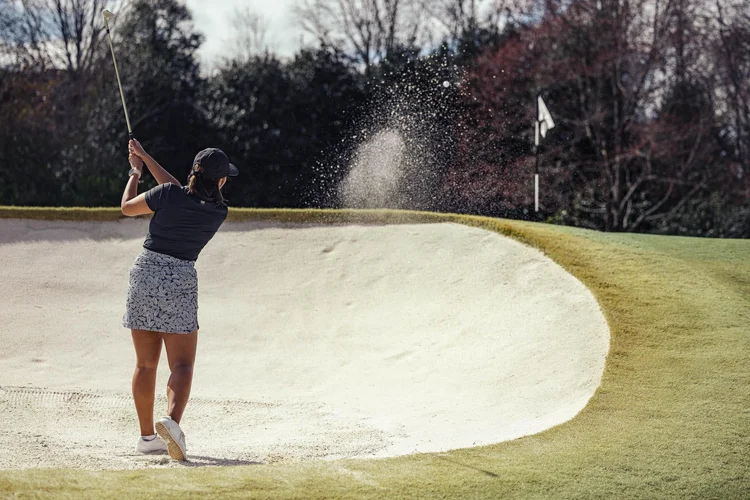 Golfer Malika Allie Thornblade on the course, editorial sports portrait