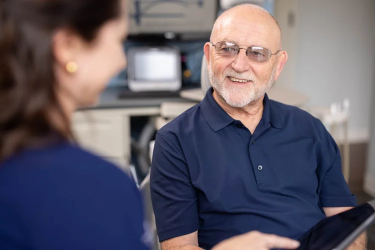 Elderly patient smiling during a consultation