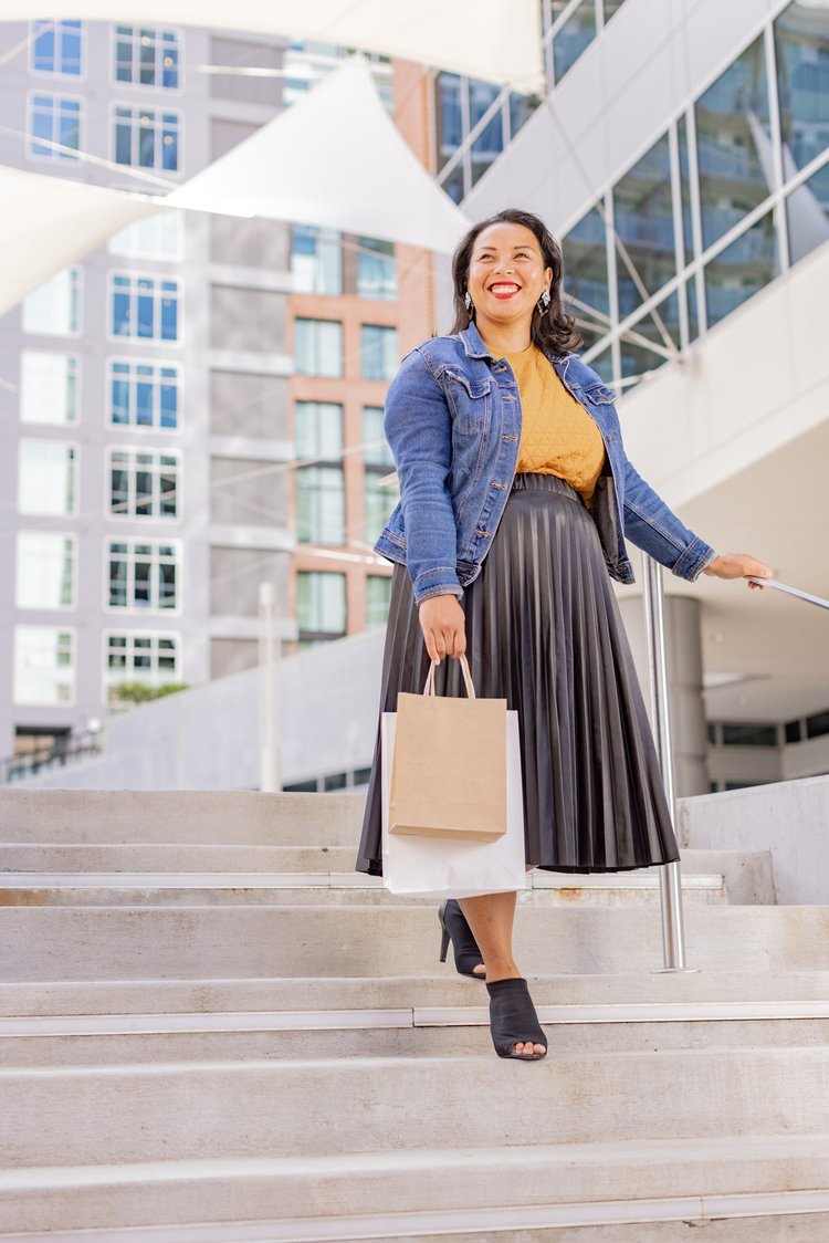 Woman with a shopping bag on the steps at Camperdown Plaza, downtown Greenville, for a City of Greenville ad campaign