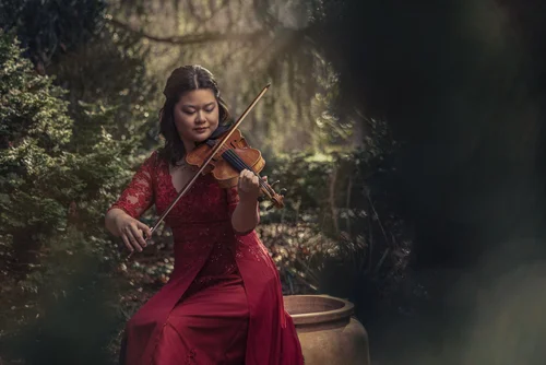 Concertmaster Jackie Tso with her violin, editorial portrait