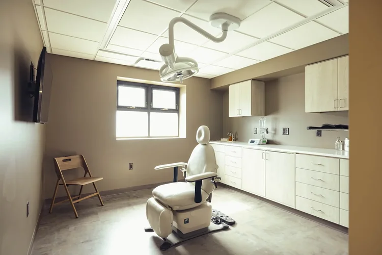 Dental clinical room with exam chair, healthcare interior photography