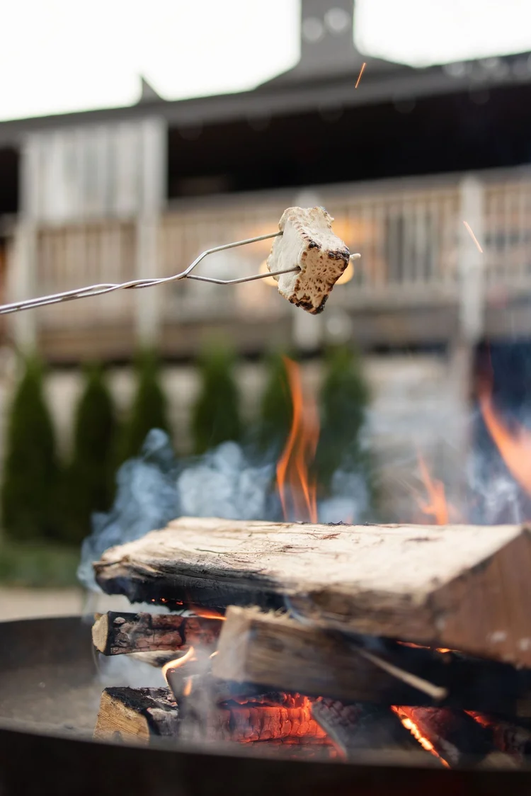 Marshmallow toasting over the fire pit for s'mores at Trailborn Highlands, Highlands, NC