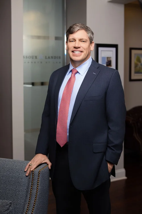 Attorney in a navy suit photographed in a Greenville, SC law office