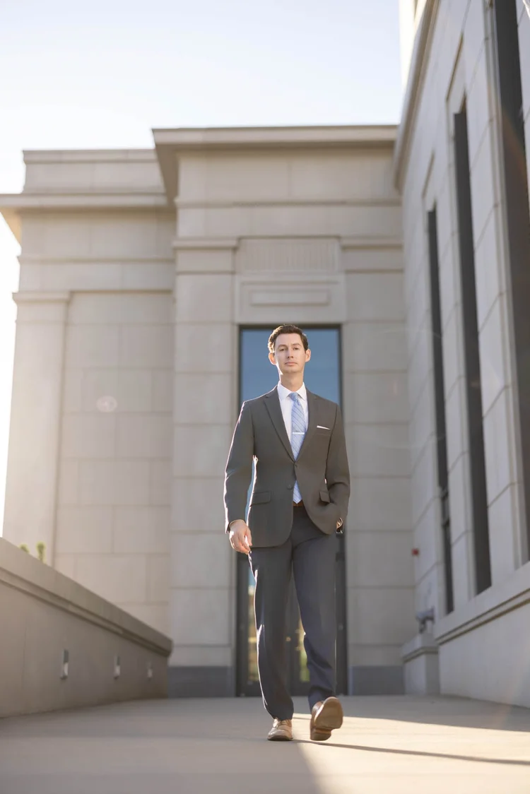 Attorney walking branding portrait in front of a courthouse