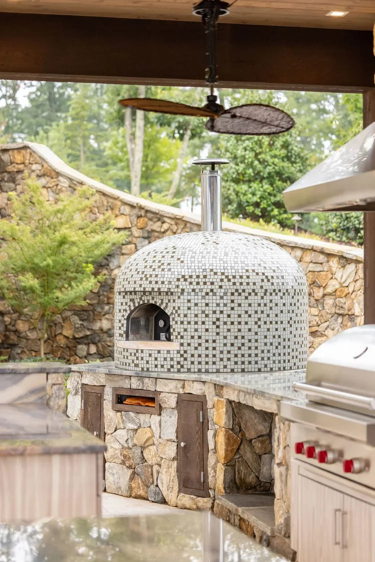 Outdoor pizza oven of a custom home in Greenville, SC, interiors by Villa Verona Design.