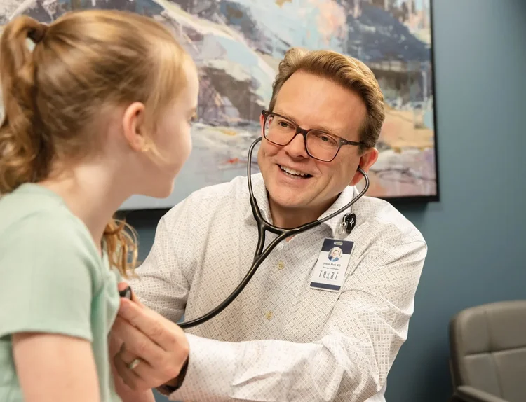 Pediatric doctor listening to a child patient