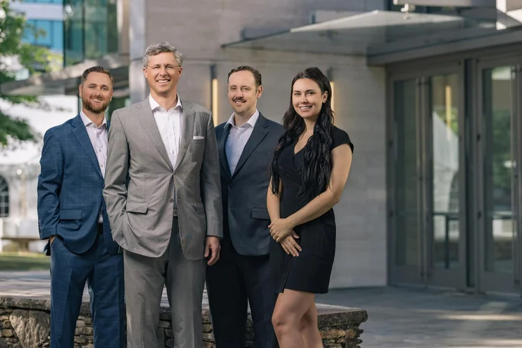 Law firm team portrait outside a modern building