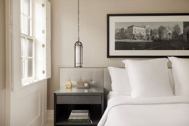 Suite bedroom with a framed photograph above the bed at Rosewood Washington, DC