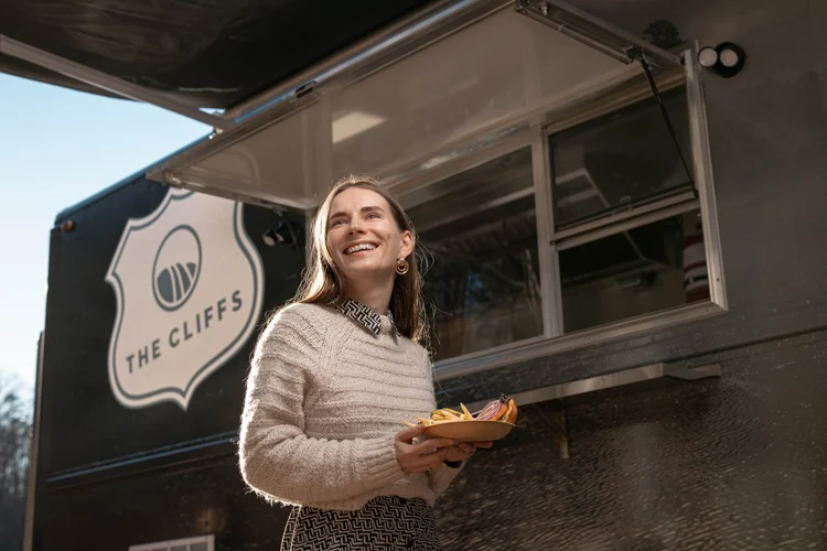 Server holding a fresh burger plate at The Cliffs food truck, Greenville SC food and beverage photography by Jack Robert