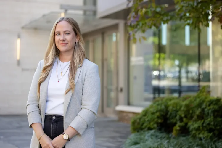 Professional LinkedIn headshot of a woman outside an office in Greenville SC