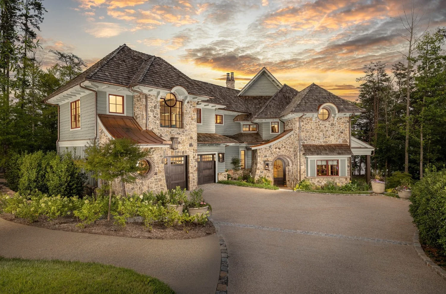 Residential architecture photography of a luxury stone home exterior at twilight in Greenville, SC by Jack Robert Photo