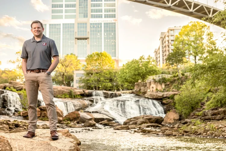 Engineering executive environmental portrait by the Reedy River in Greenville, SC