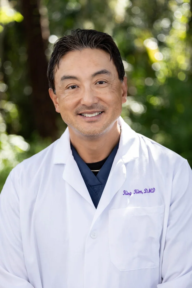 Professional headshot of Dr. King Kim in a lab coat