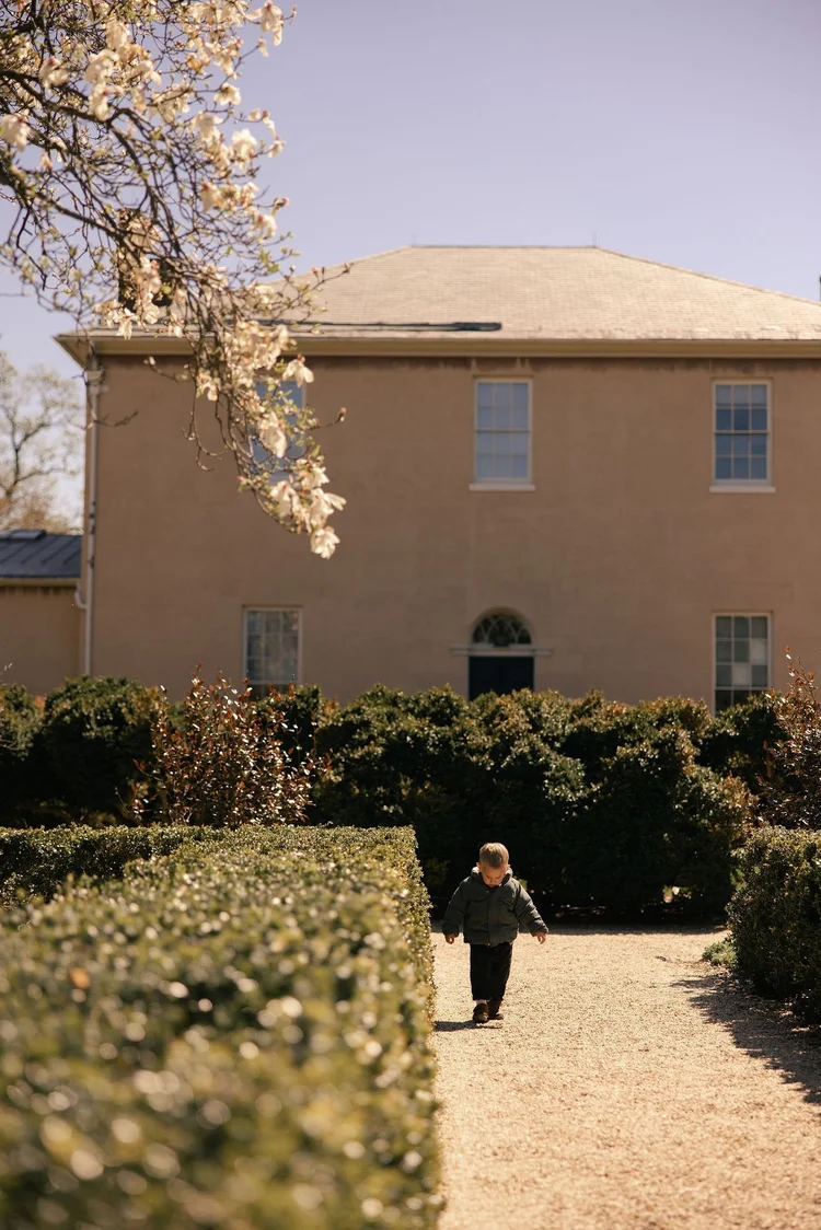Child walking through a historic garden, Washington, DC