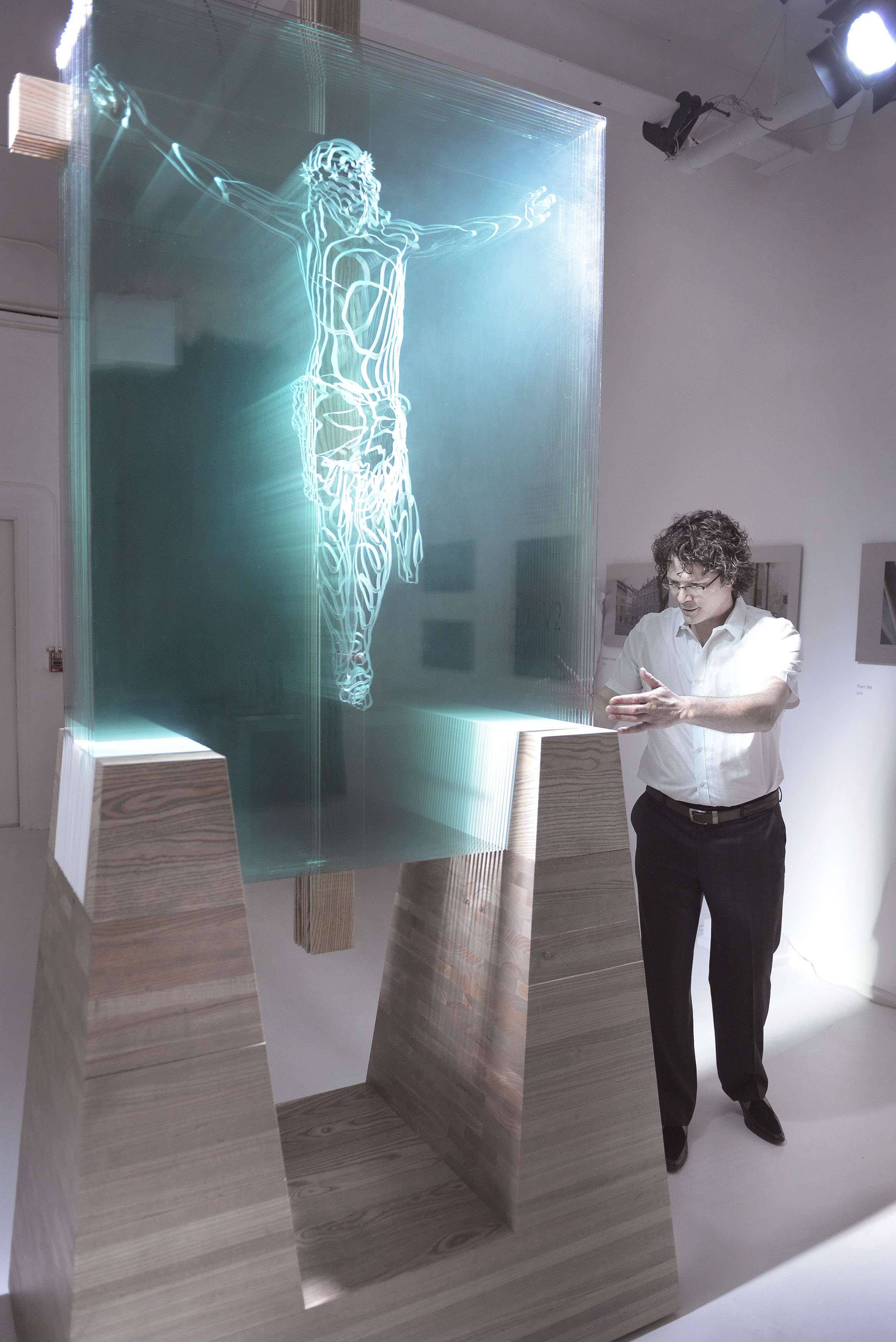 Front view showing sculpted glass and halo of light along the left side of His body.