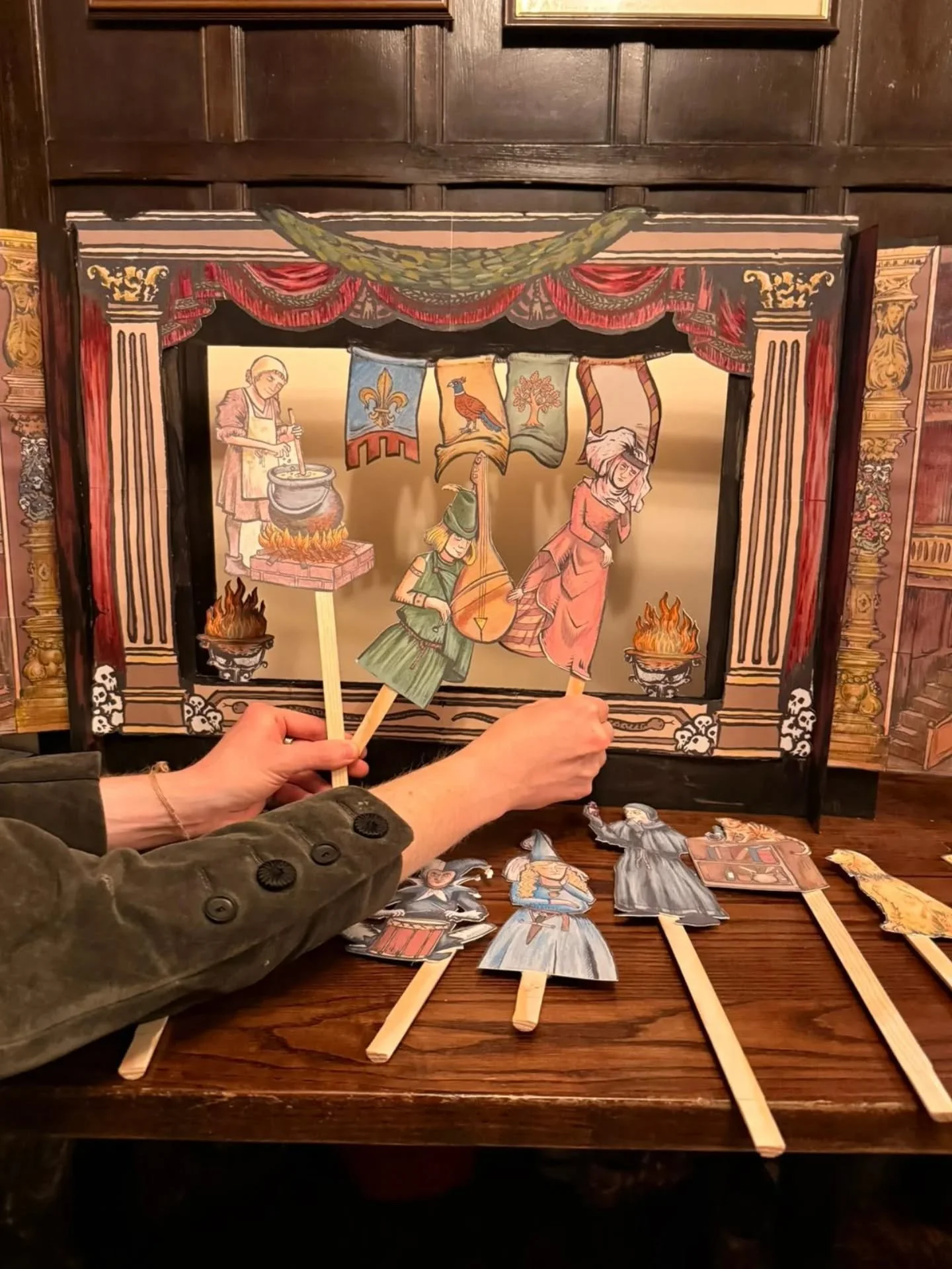 Once a year I get to design puzzles for a job and it's very lovely.

A script composed of riddles, visual clues, and a logic puzzle leads to placing the puppets in the correct order in the theatre, and then, surprise! The light turns on revealing a p